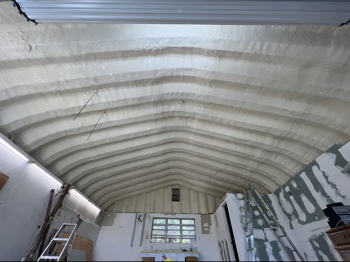 Spray polyurethane foam applied to the underside of a metal roof deck in Deale
